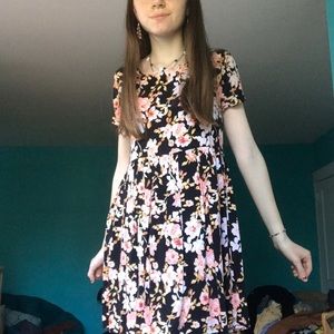 Black flowy dress with large pink flowers.